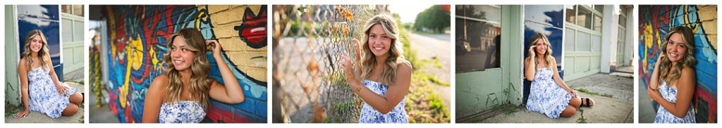High school senior girl with long wavy blonde hair wearing a blue floral strapless dress, photographed against colorful graffiti murals in an urban area of Indianapolis, near a chain-link fence in one image and leaning against a painted garage door in another, during her senior photoshoot with Amanda Duncan Photography.